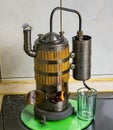 The process of distilling wine at a mini distillery using wood. Volume 400 ml. Royalty Free Stock Photo