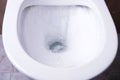 Process of draining water in  bowl of  rimless toilet bowl Royalty Free Stock Photo