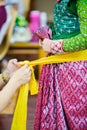 The process of dressing the Thai pantomime for the actors with hand sewing, repairing