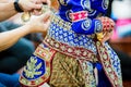 The process of dressing the Thai pantomime for the actors with hand sewing, repairing