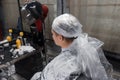 The process of dyeing hair in a barbershop, the guy's head is wrapped in plastic wrap for professional dyeing