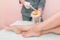 The process of epilation of the legs or parts of the female body using the sugaring method