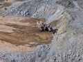Process of extracting and loading minerals with giant excavators into mining dump trucks Royalty Free Stock Photo