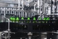 The process of filling beer into bottles on a production conveyor line Royalty Free Stock Photo