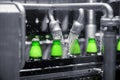 The process of filling beer into bottles on a production conveyor line. Royalty Free Stock Photo