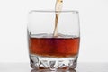 Glass of whiskey with ice isolated on white background Royalty Free Stock Photo