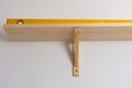 The process of attaching a wooden shelf to the wall