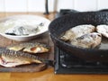 The process of frying river fish crucian carp in a pan on a kitchen stove.River fish of Russian rivers Royalty Free Stock Photo