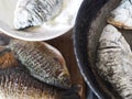 The process of frying river fish crucian carp in a pan on a kitchen stove.River fish of Russian rivers Royalty Free Stock Photo