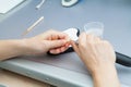 Process of grinding the jaw during production. The dental technician processes artificial teeth with a micromotor.