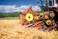 Process of harvesting with combine, gathering mature grain crops Royalty Free Stock Photo