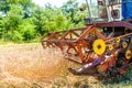Process of harvesting with combine, gathering mature grain crops Royalty Free Stock Photo