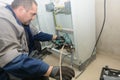 Process of installing 0.4 kilovolt cable sleeve. An electrical engineer connects the electrical cable to control cabinet