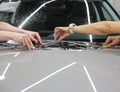 The process of installing PPF on the hood of the car. Anti-gravity protection. PFF is installed. Royalty Free Stock Photo