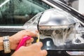 The process of installing PPF on the side mirror. Car wrapping. Royalty Free Stock Photo