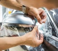 The process of installing PPF on the side mirror. Car wrapping. Royalty Free Stock Photo