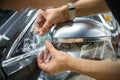 The process of installing PPF on the side mirror. Car wrapping. Royalty Free Stock Photo