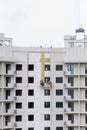 The process of insulating external walls in a multi-storey building under construction Royalty Free Stock Photo