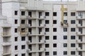 The process of insulating external walls in a multi-storey building under construction Royalty Free Stock Photo