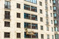 The process of insulating external walls in a multi-storey building under construction Royalty Free Stock Photo