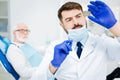 Close up of attentive dentist with Xray image