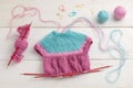 The process of knitting a doll dress on knitting needles, knitting accessories