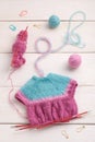 The process of knitting a doll dress on knitting needles, knitting accessories