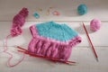 The process of knitting a doll dress on knitting needles, knitting accessories