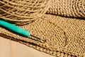 The process of knitting a raffia bag, a skein of yarn, a crochet hook