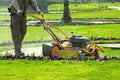 Process of lawn mowing, concept of mowing the lawn, lawnmower cutting grass with gardening tools.. Royalty Free Stock Photo
