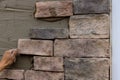 The process of laying decorative stone bricks on the wall. Royalty Free Stock Photo