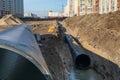 The process of laying of engineering and heating systems. black plastic pipes are in trench of ground Royalty Free Stock Photo