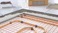 Process of laying tiles on floor with underfloor heating Royalty Free Stock Photo