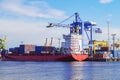 The process of loading containers onto a cargo ship container ship. Port of St. Petersburg Royalty Free Stock Photo