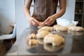 The process of making bread. Dividing the wheat dough into pieces for buns.