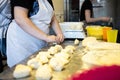 The process of making bread. Dividing the wheat dough into pieces for buns.