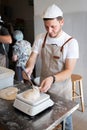 The process of making bread. Dividing the wheat dough into pieces.