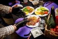 The process of making a burger in a restaurant kitchen. Chef in black gloves prepares ingredients.