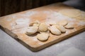 Process of making chinese dumplings. Raw dough on wooden chopping board Royalty Free Stock Photo