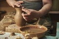 Process of making clay pot on potter`s wheel in workshop. Potter at work Royalty Free Stock Photo