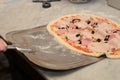 Process of making delicious pizza with ham, cheese and olives and a pizza