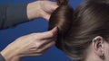 Process of making the hairstyle by hairdresser, hair stylist makes the bouffant for her client, making of the hairstyle