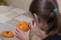 The process of making a Halloween pumpkin. cutting out the mouth by brunette girl. horror theme and Hallowe`en Royalty Free Stock Photo