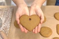 Process of making heart-shaped gingerbread for Valentine& x27;s Day. Cutting hearts out of dough with cookie-cutters Royalty Free Stock Photo