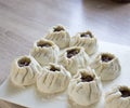 The process of making home-made dumplings. Raw homemade dumplings on a wooden board. Molding dumplings Royalty Free Stock Photo