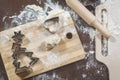 The process of making homemade cookies. Wooden boards with flour, dough and the cookie cutters in the shape of `heart`, `stars` an Royalty Free Stock Photo