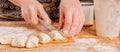 Process of making homemade dumplings. Beautiful young woman making Ukrainian dumplings with potatoes and cheese stuffing.