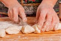 Process of making homemade dumplings. Close up young woman making Ukrainian dumplings with potatoes and cheese stuffing.