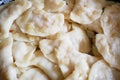 Process of making homemade dumplings, ravioli or pelmeni with vegetables filling. Ready for cooking raviolis on wooden board Royalty Free Stock Photo