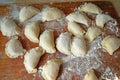 Process of making homemade dumplings, ravioli or pelmeni with vegetables filling. Ready for cooking raviolis on wooden board Royalty Free Stock Photo